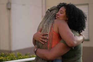 woman embracing her friend as she struggles to employ one of the 5 ways to help a friend with depression