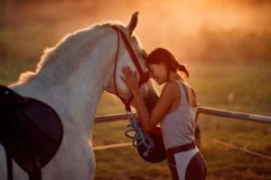 woman participates in equine-assisted therapy