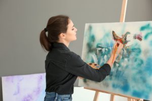 woman practices art therapy to nurture creativity