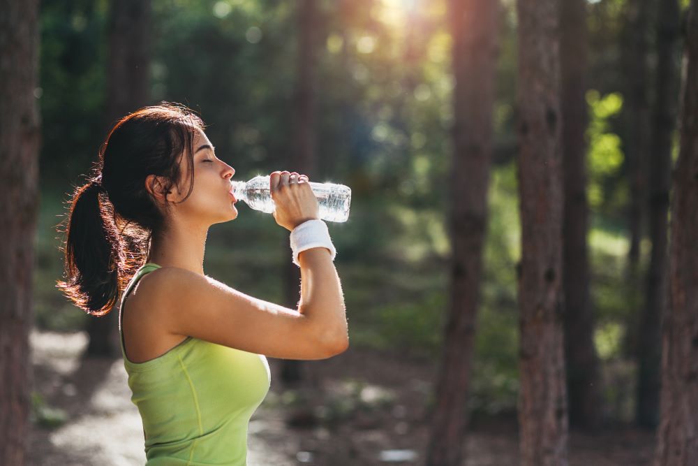 woman drinks water to stay hydrated