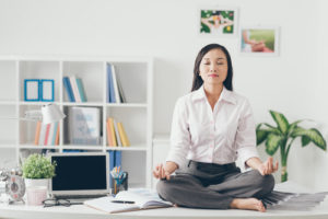 woman meditates at work