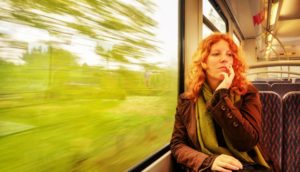 woman sits on train