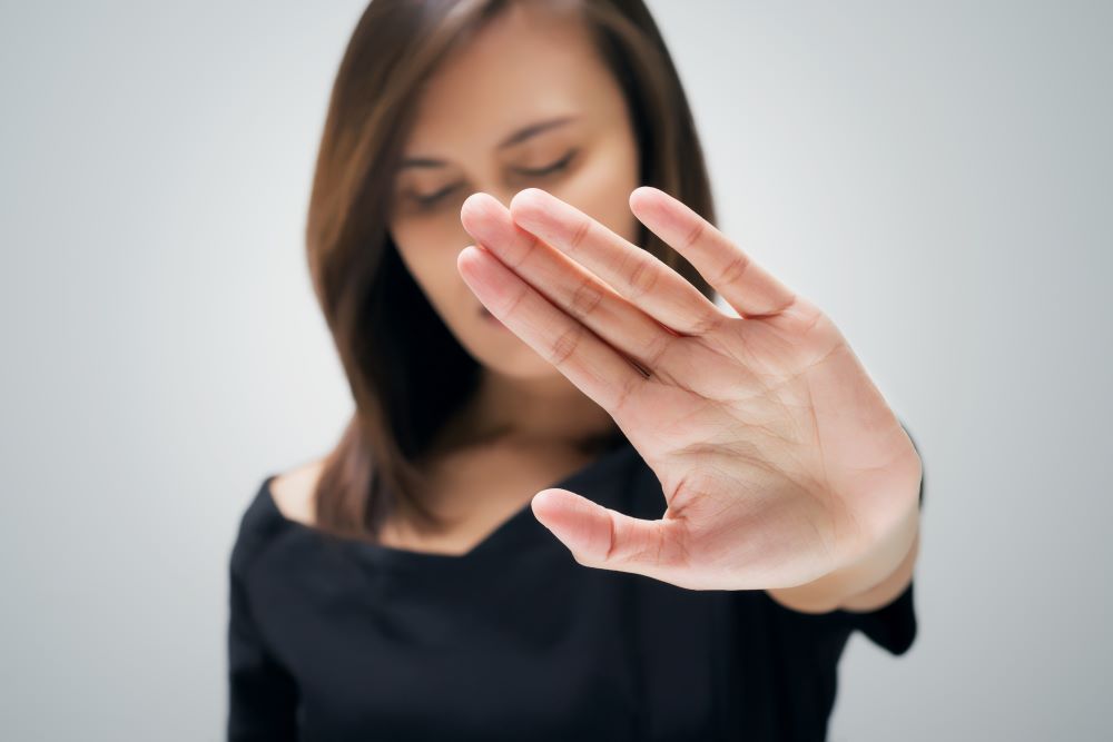 woman puts up her hand to say no