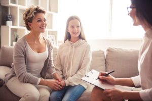 woman and daughter participate in cognitive behavioral therapy