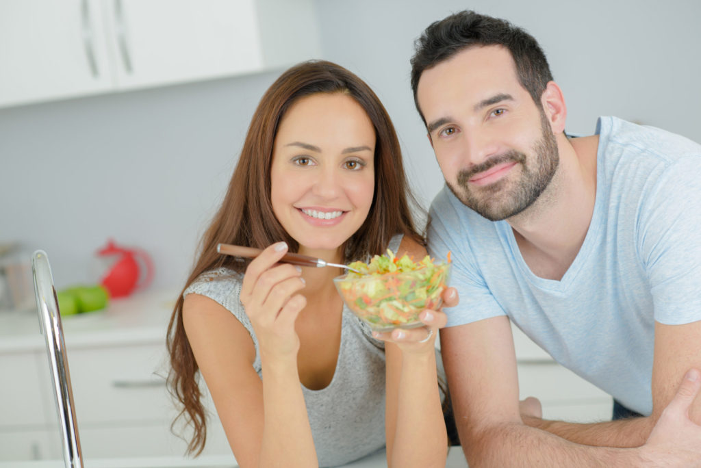 woman and man share a salad
