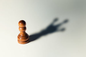 pawn chess piece casts shadow