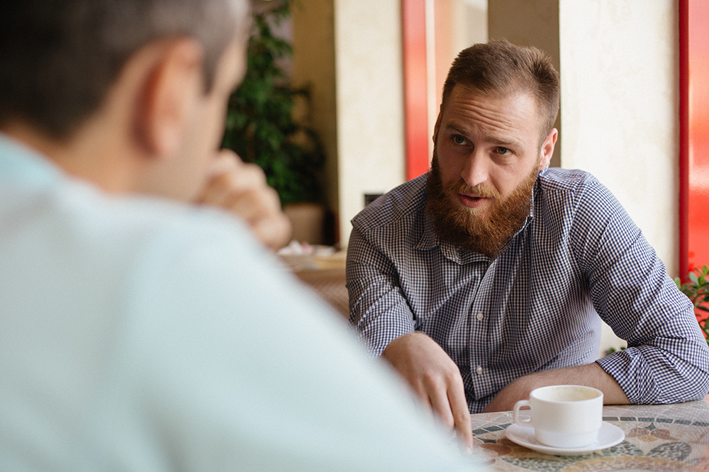 man speaks to friend about setting boundaries