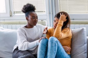 woman discusses negative thoughts with friend