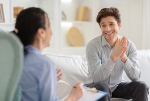 man discusses negative thinking with therapist