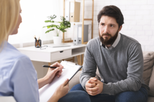 man talks with therapist about 12-step groups
