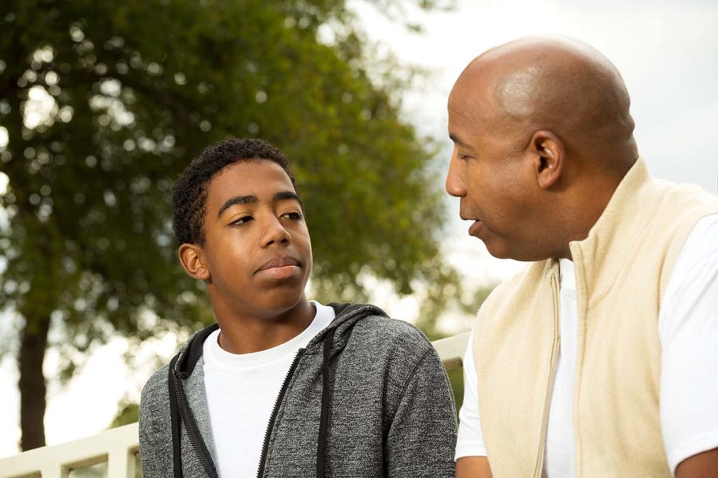 man talks to teen about drug and alcohol use