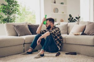 man struggles with signs of alcoholism