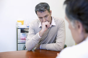 man discusses substance abuse and thyroid function with doctor