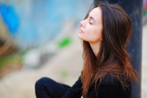 woman meditates and practices mental wellness