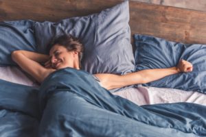 woman enjoys healthy sleep upon waking