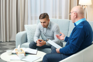 man discusses alcohol use with counselor
