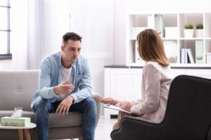 man discusses depression with therapist