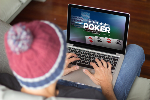 man plays online poker