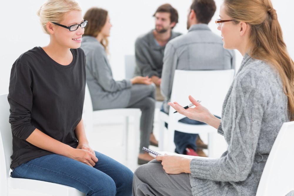 woman discusses coping skills with therapist