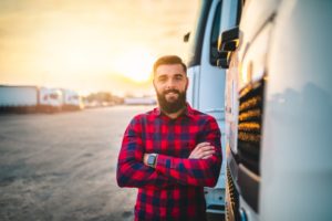 man poses outside truck