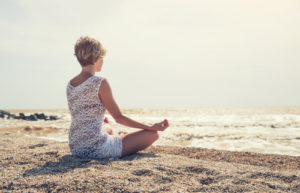 woman practices mindfulness through meditation