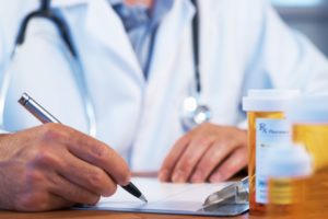 doctor writes painkiller prescription