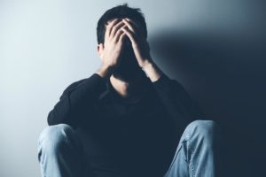 a man struggles to cope with his drug and alcohol withdrawal signs and symptoms