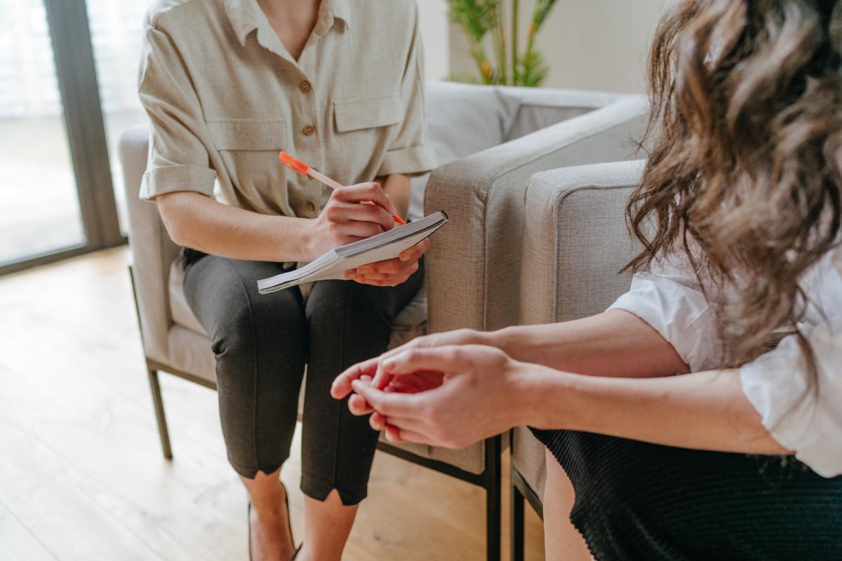 A female patient discusses her connection between substance and happiness with a therapist
