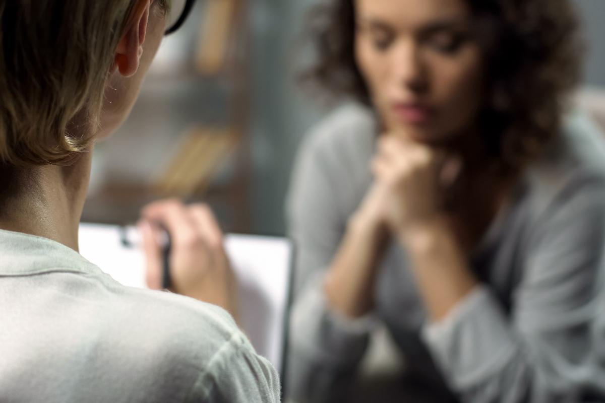 A woman contemplating the question, "What is cognitive dissonance?"