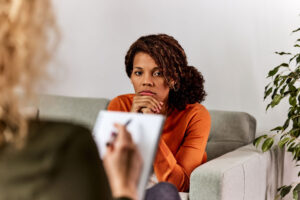 therapist discussing with young woman about finding depression treatment near Dallas, TX