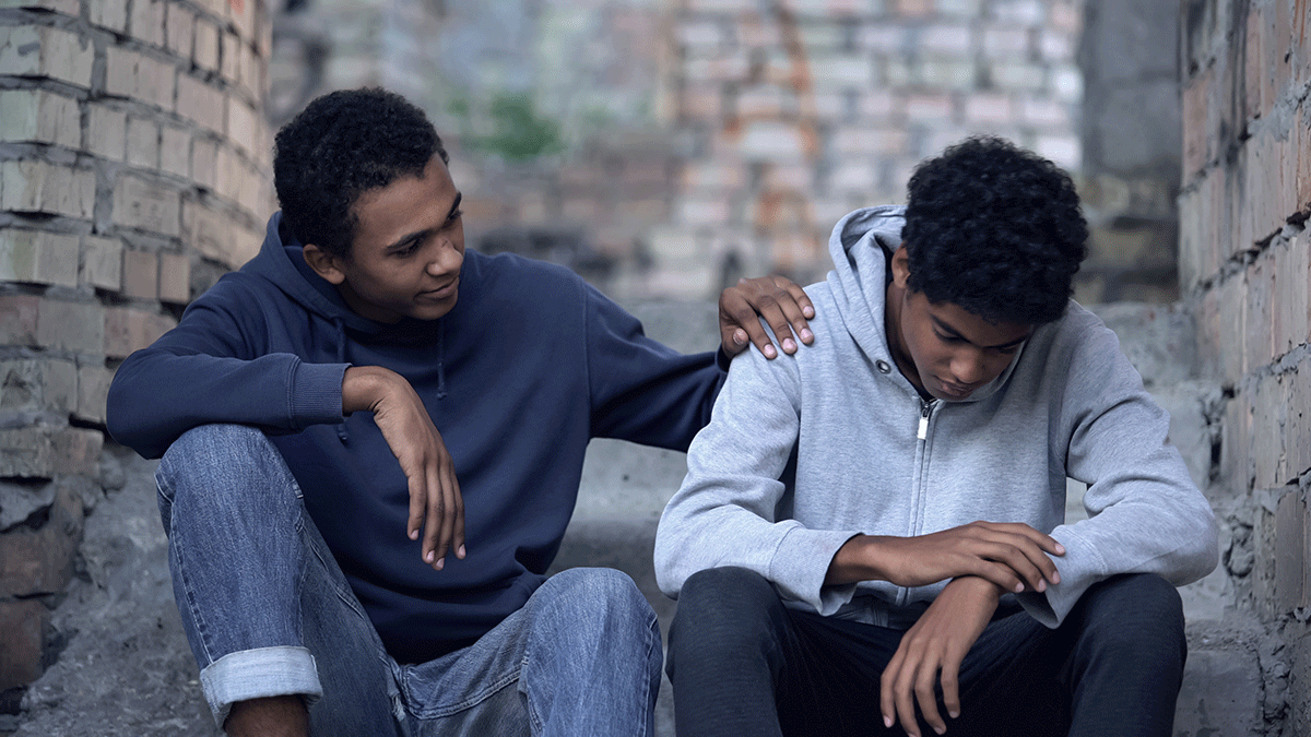 Older brother consoling younger brother by helping a loved one with xanax addiction