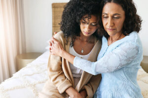 Two women displaying family support in recovery