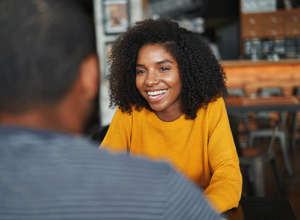 smiling woman talking to her advocate as part of an  Advocacy Program for addiction treatment and recovery.