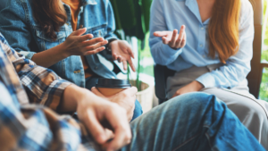 close up of group therapy session where indivdiuals learn the impact of peer support in recovery groups