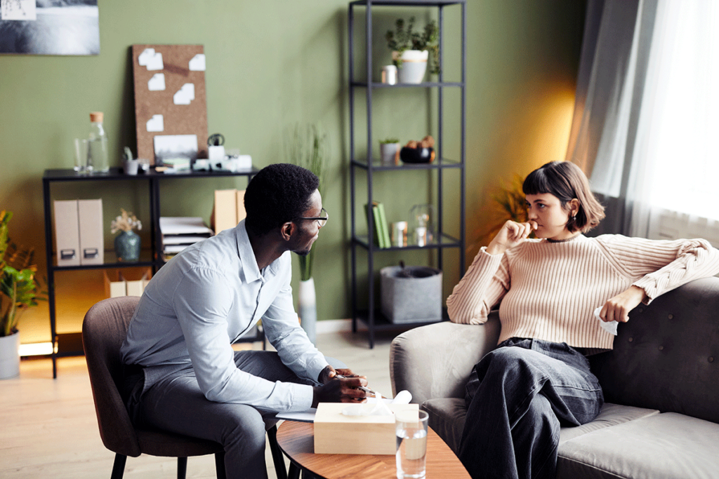 male therapist discussing with female client how sober living programs support long term recovery