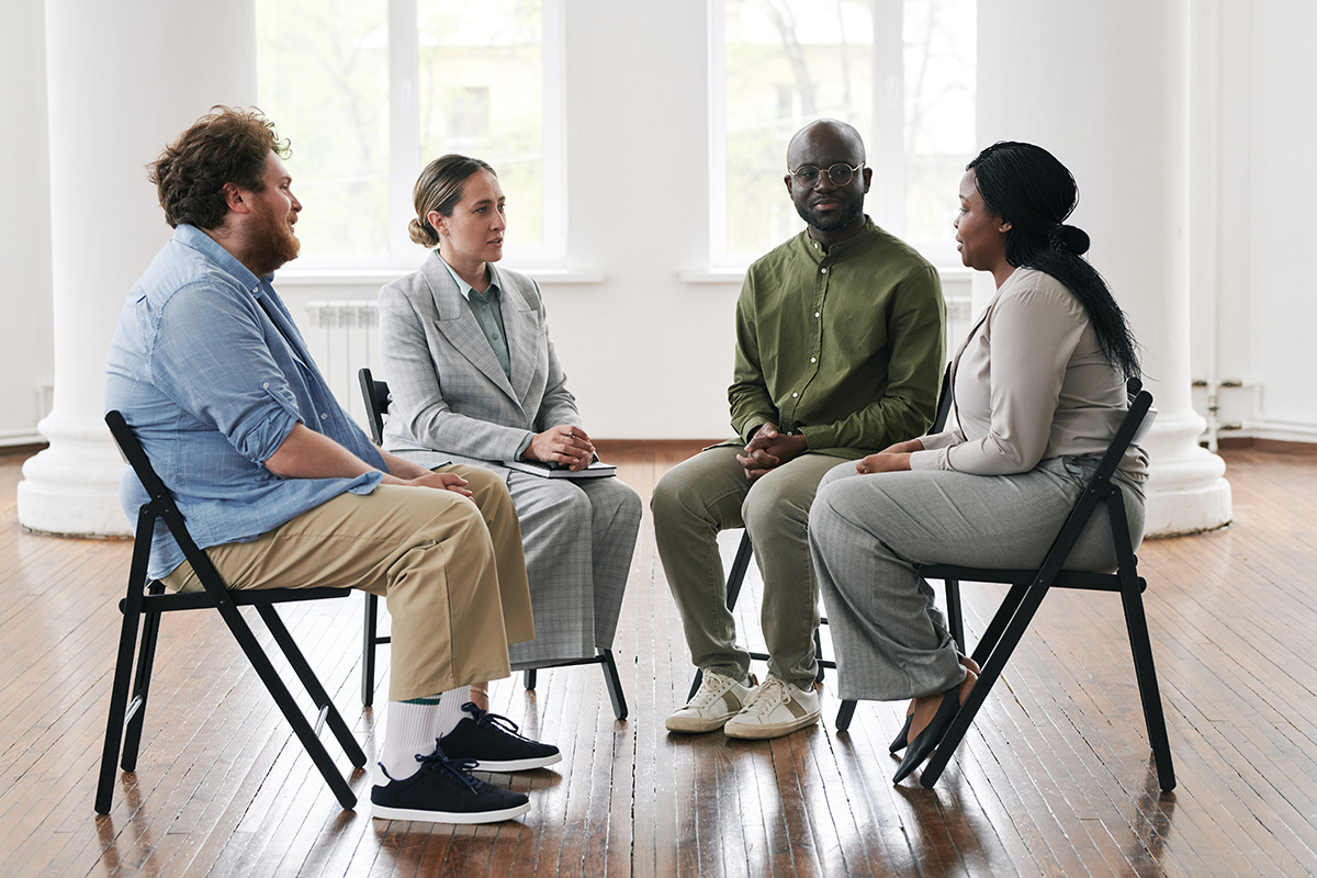 A group of people discuss substance abuse interventions