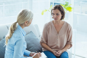 Upset woman talking to therapist