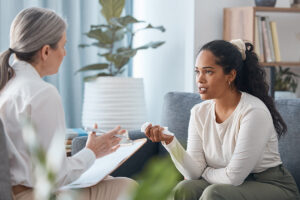 Psychologist, therapy and woman talking in consultation for mental health in office. Therapist, psychology and female patient consulting, counseling and discussion for depression, stress and crying