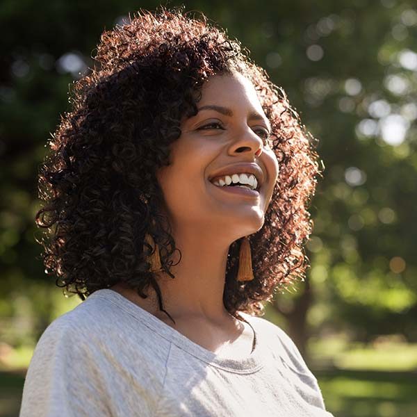 woman smiles in outdoors